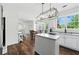 Bright kitchen featuring white cabinets, an island, and an adjacent dining area at 312 Laurel Run Cv, Sugar Hill, GA 30518