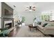 Spacious living room with a fireplace, comfortable seating, and hardwood floors at 312 Laurel Run Cv, Sugar Hill, GA 30518