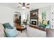 Cozy living room with fireplace, comfortable seating, and view into adjacent office at 312 Laurel Run Cv, Sugar Hill, GA 30518