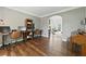 Open-concept living area with hardwood floors, multiple desks, an area with a piano, and lots of natural light at 312 Laurel Run Cv, Sugar Hill, GA 30518