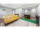 Spacious living room featuring a billiards table, wet bar and stylish yellow couch at 312 Laurel Run Cv, Sugar Hill, GA 30518
