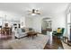 Bright and open living room adjacent to kitchen with archway and a fireplace at 312 Laurel Run Cv, Sugar Hill, GA 30518