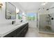 Sleek primary bathroom with double vanity, modern fixtures, and a glass enclosed shower at 312 Laurel Run Cv, Sugar Hill, GA 30518