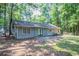 Backyard showcasing the rear of the home with patio and trees at 4116 Wendell Way, Snellville, GA 30039
