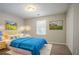 Comfortable bedroom with blue bedding, a large window for natural light, and ample closet space at 4116 Wendell Way, Snellville, GA 30039