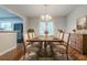 Dining room featuring a wooden table set for eight, complemented by a sideboard and hardwood floors at 4116 Wendell Way, Snellville, GA 30039