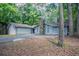 Beautiful single-story home with an attached garage, complemented by a stone chimney and lush landscaping at 4116 Wendell Way, Snellville, GA 30039