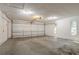 Garage featuring concrete floors, white walls, and a white garage door at 4116 Wendell Way, Snellville, GA 30039