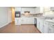 Bright kitchen with white cabinets and a neutral backsplash at 4116 Wendell Way, Snellville, GA 30039