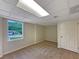 Finished basement with neutral carpeting, window, and closet at 8272 Magnolia Dr, Jonesboro, GA 30238
