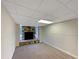 Finished basement featuring a stone fireplace and neutral carpeting at 8272 Magnolia Dr, Jonesboro, GA 30238