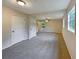 Spacious primary bedroom with neutral carpeting, ceiling fan, and two windows at 8272 Magnolia Dr, Jonesboro, GA 30238