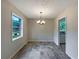 Dining room featuring stylish floors and a modern chandelier at 8272 Magnolia Dr, Jonesboro, GA 30238