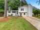 Charming renovated two-story home featuring a freshly painted exterior, landscaped yard, and front porch at 8272 Magnolia Dr, Jonesboro, GA 30238