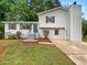 Charming home with a well-manicured front yard and inviting curb appeal with a gray painted brick at 8272 Magnolia Dr, Jonesboro, GA 30238