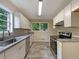 Well-lit kitchen with stainless steel appliances, granite countertops, and white cabinets at 8272 Magnolia Dr, Jonesboro, GA 30238