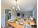 Bright living room with modern chandelier, stylish furniture, and open layout, virtually staged at 8272 Magnolia Dr, Jonesboro, GA 30238
