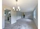 Open-concept living space with gray floors that flows seamlessly into the adjacent kitchen area at 8272 Magnolia Dr, Jonesboro, GA 30238