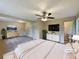 Spacious primary bedroom with ample closet space, en-suite bathroom, and modern ceiling fan, virtually staged at 8272 Magnolia Dr, Jonesboro, GA 30238
