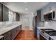 Modern kitchen with stainless steel appliances, granite countertops, and hardwood floors at 1840 Linwood Ave, Atlanta, GA 30344