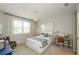 Bright bedroom features a geometric-patterned rug, study desk and chair, and white-framed bed with a blue throw at 2535 Castlerock Ct, Cumming, GA 30041