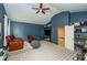 Spacious blue bonus room features leather seating, a large TV, and built-in shelving for organization at 2535 Castlerock Ct, Cumming, GA 30041