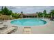 Community pool with lounge chairs and lush landscaping at 2535 Castlerock Ct, Cumming, GA 30041