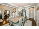 Formal dining room with wainscoting, wood floors, and views into the office at 2535 Castlerock Ct, Cumming, GA 30041
