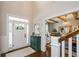 Light and airy foyer with hardwood floors, decorative cabinet, and views into adjacent rooms at 2535 Castlerock Ct, Cumming, GA 30041