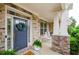 Inviting covered front porch featuring rocking chairs and a wreath-adorned front door at 2535 Castlerock Ct, Cumming, GA 30041