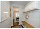 Entry hallway features a built-in bench, white cabinets, and access to the dining area at 2535 Castlerock Ct, Cumming, GA 30041