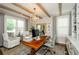 Comfortable home office with a large desk, built-in shelving, and comfortable seating at 2535 Castlerock Ct, Cumming, GA 30041