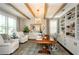 Bright home office featuring exposed beams, custom shelving, and a large desk at 2535 Castlerock Ct, Cumming, GA 30041