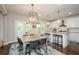 Bright kitchen features white cabinets, an island with seating, and access to an outdoor patio at 2535 Castlerock Ct, Cumming, GA 30041