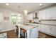 Well-lit kitchen with white cabinets, granite countertops, and a subway tile backsplash at 2535 Castlerock Ct, Cumming, GA 30041