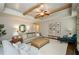Bright living room with beamed ceilings, neutral decor, and plenty of seating at 2535 Castlerock Ct, Cumming, GA 30041