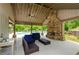 Outdoor living space featuring a stone fireplace and comfortable seating at 2535 Castlerock Ct, Cumming, GA 30041