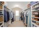 Organized walk-in closet with custom shelving and ample storage for clothes and shoes at 2535 Castlerock Ct, Cumming, GA 30041