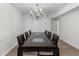 Formal dining room featuring a grand chandelier, long table and seating, perfect for hosting elegant dinner parties at 6851 Roswell Rd # L1, Atlanta, GA 30328