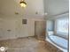 Bathroom featuring a soaking tub, shower with glass enclosure, and decorative window at 1292 Hidden Spirit Trl, Lawrenceville, GA 30045