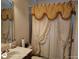 Cozy bathroom featuring a vanity, mirror, and shower with decorative curtains at 1292 Hidden Spirit Trl, Lawrenceville, GA 30045