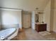 Bathroom featuring a soaking tub and vanity with ample storage at 1292 Hidden Spirit Trl, Lawrenceville, GA 30045