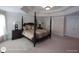 The primary bedroom features carpeted floors, a four poster bed, and a tray ceiling at 1292 Hidden Spirit Trl, Lawrenceville, GA 30045