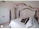 Bedroom featuring a stylish four-poster bed and double closets, providing ample storage at 1292 Hidden Spirit Trl, Lawrenceville, GA 30045