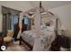 Cozy bedroom featuring a unique canopy bed with a floral-patterned comforter and decorative accents at 1292 Hidden Spirit Trl, Lawrenceville, GA 30045