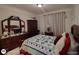 Bedroom featuring a bed with a decorative quilt and dark wood furniture at 1292 Hidden Spirit Trl, Lawrenceville, GA 30045