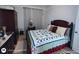 Comfortable bedroom featuring a bed with a decorative quilt and dark wood furniture at 1292 Hidden Spirit Trl, Lawrenceville, GA 30045