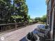Spacious wooden deck with railing and chairs, overlooking a lush green landscape at 1292 Hidden Spirit Trl, Lawrenceville, GA 30045
