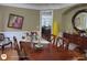 Warm dining room with hardwood floors, a wooden table set for a meal, and decorative accents at 1292 Hidden Spirit Trl, Lawrenceville, GA 30045