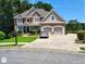 Beautiful two-story home with manicured lawn, two-car garage, and brick and stucco exterior at 1292 Hidden Spirit Trl, Lawrenceville, GA 30045